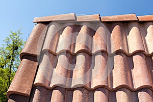 Roof tile pattern over blue sky.
