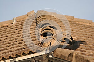 Roof tiles are ripped up from Hurricane winds.