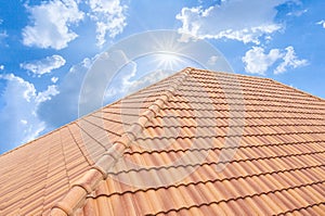 Roof tiles and sky sunlight. Roofing Contractors concept Installing