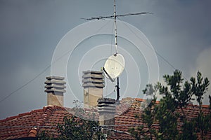 Roof top of a country house with antennae