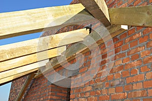 Roof-trusses. Close up on installation of wooden beams at construction the roof truss system of the house. Roofing Construction.