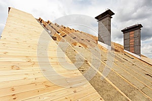 Roof under construction.Installation mineral wool insulation