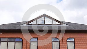 Roof and upper level of contemporary brick built corporate edifice