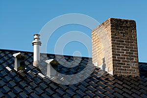 Roof with ventilation, flue terminal and chimney photo