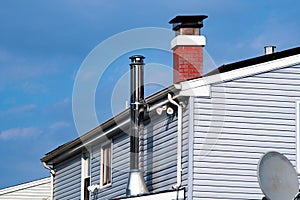 Roof with ventilation pipe and flue terminal modern