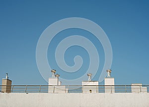 roof ventilators against a blue sky