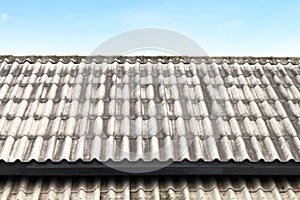 Roof wavy tile, roofing tile old, white or grey roofing tile old on sky background