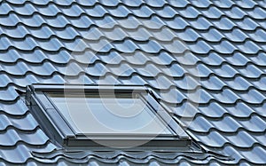 Roof window on a grey tiled rooftop large detailed loft skylight
