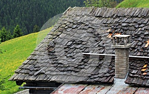 Roof of wooden shingles and stone chimney