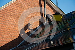 Roof worker and his shadow