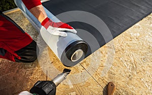 Roof Worker with Roll of EPDM Rubber Membrane