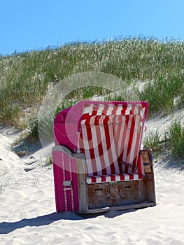 Roofed wicker beach chair on the beach