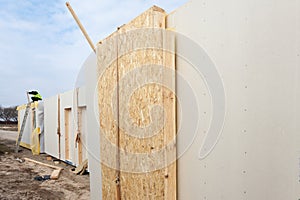 Roofer builder worker with crane installing structural Insulated Panels SIP. Building new frame energy-efficient house.