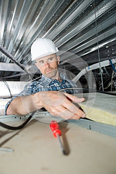 Roofer builder worker installing roof insulation material