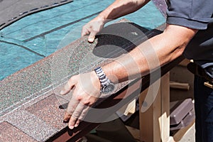 Roofer builder worker installing roof shingles