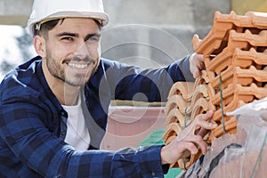 roofer builder worker in between tiles