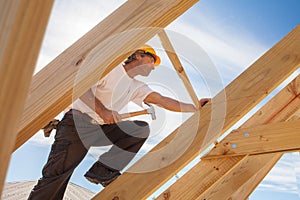 Roofer,builder working on roof structure of building on construction site