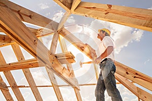 Roofer,builder working on roof structure of building on construction site