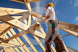 Roofer,builder working on roof structure of building on construction site