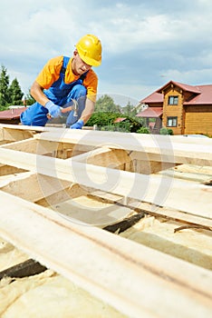 Roofer carpenter works on roof