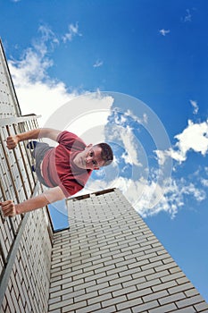 Roofer descends stairs from roof