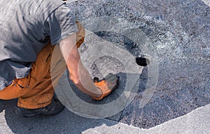 Roofer doing repair roof drain.