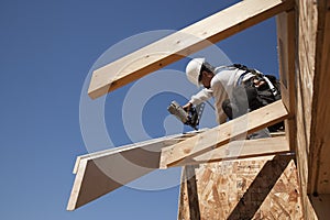 Roofer fixing beams on roof