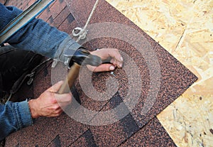 Roofer Install Asphalt Roof Shingles. Close up view on Roofer Installation Asphalt Roofing Shingles Installation.