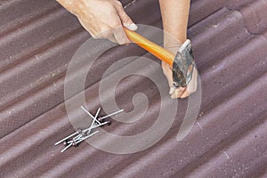 Roofer installs asphalt shingles Ondulin, roof repair