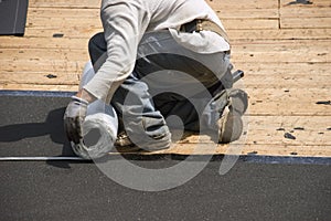 Roofer on Roof, Ice Shield Tar Paper Shingles photo