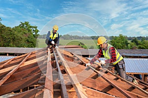 Roofer, Two worker roofer builder working on roof structure on construction site, Teamwork construction concept