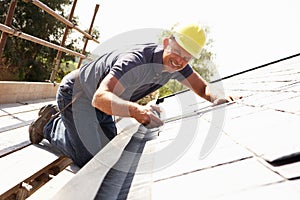 Roofer Working On Exterior photo