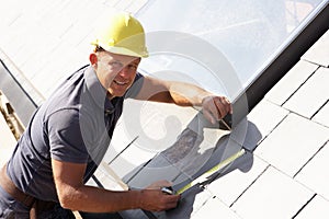 Roofer Working On Exterior photo