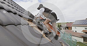 Roofer working on roof on a private home