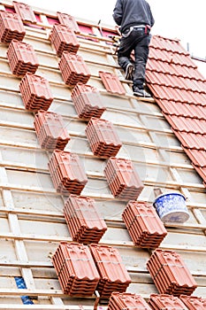 Roofer working on roof structure of building on construction sit