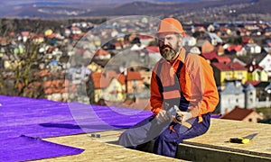Roofer working on roof structure of building on construction site. roofer wear safety uniform inspection. Roofer working