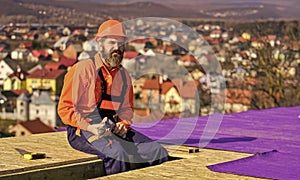 roofer working on roof structure of building on construction site. roofer wear safety uniform inspection. Roofer working