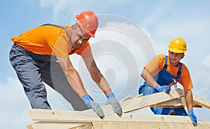 Roofers carpenters works on roof