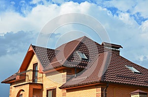 Roofing construction with attic skylights, rain gutter system, roof windows and roof protection from snow snow guard house