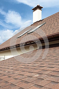 Roofing construction and building new house with modular chimney, skylights, attic, dormers and eaves.