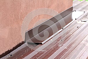 Roofing construction detail close-up. Metal panel on house roof