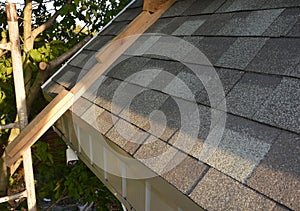 Roofing Construction.  Installing, Repair, Renovate  Asphalt Shingles Roof Tiles on the Rooftop Outdoors photo