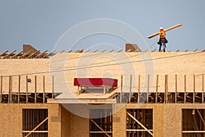 Roofing construction. Roofer roofing on roof structure. Roofing Wooden House Frame. Worker roofer builder working on