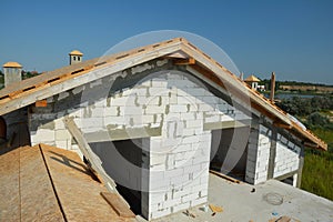 Roofing construction with trusses, wooden beams on new house building. Rooftop view