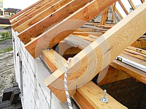 Roofing construction with wooden beams, logs, rafters, trusses.