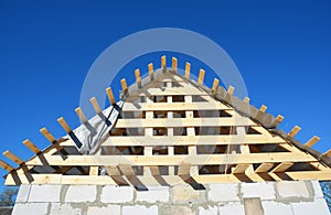 Roofing Construction. Wooden roof top frame house construction  with wooden roof beams, trusses, timber