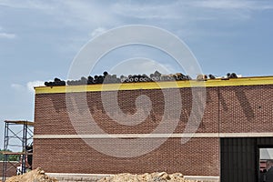 Roofing materials on roof of building under construction