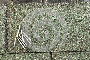 Roofing nails on shingle photo