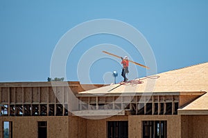 Roofing on roof. Builder roofer install new roof. Construction worker roofing on a large roof apartment building