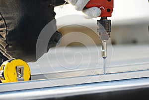 Roofing technician with screwdriver